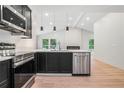 Modern kitchen features stainless steel appliances, black cabinets and an island with a sink at 3052 Brook Dr, Decatur, GA 30033
