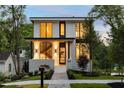 Modern home exhibiting a well-lit porch and manicured landscaping at 3117 Robinson Ave, Scottdale, GA 30079