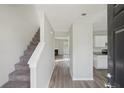Welcoming entryway with a staircase, sleek floors, and access to the living spaces at 7099 Skippingstone Way, Douglasville, GA 30134