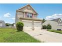Beautiful two-story home with two-car garage and manicured landscaping at 7099 Skippingstone Way, Douglasville, GA 30134