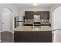 Modern kitchen with stainless steel appliances, granite countertops and center island at 7099 Skippingstone Way, Douglasville, GA 30134