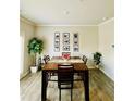 Dining room with wood floors, ample natural light, and modern decor at 776 Woodstock Grove Dr, Woodstock, GA 30188