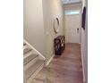 Inviting entryway with wood flooring, a stylish console table, and access to the staircase at 776 Woodstock Grove Dr, Woodstock, GA 30188