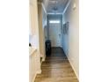 Inviting entryway with wood-look flooring, leading to a bright interior, decorated with modern touches at 776 Woodstock Grove Dr, Woodstock, GA 30188