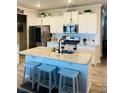 Modern kitchen featuring a large island, granite countertops, stainless steel appliances, and ample cabinet space at 776 Woodstock Grove Dr, Woodstock, GA 30188