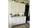 Kitchenette with white cabinets, granite countertops, and white brick backsplash at 776 Woodstock Grove Dr, Woodstock, GA 30188