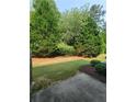 A grassy yard with large mature trees, a perfect outdoor space for a quiet time at 803 Arbor Gate Ln, Lawrenceville, GA 30044