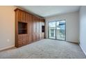 Bedroom features custom wood wardrobe and sliding glass doors to balcony with city views at 1280 W Peachtree Nw St # 3514, Atlanta, GA 30309