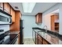 Cozy kitchen featuring granite countertops, stainless steel appliances, and wooden cabinets at 1280 W Peachtree Nw St # 3514, Atlanta, GA 30309