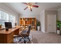 Bright home office featuring a built-in bookcase, large window, and comfortable workspace at 1453 Graham Sw St, Atlanta, GA 30310