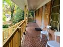 Cozy front porch with a brick floor, wooden railing, and seating at 1723 Fort Valley Sw Dr, Atlanta, GA 30311