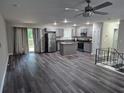 Open-concept kitchen and living area with new flooring, stainless appliances, and modern gray cabinets at 3975 Northstrand Dr, Decatur, GA 30035