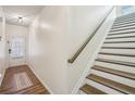 Hallway with hardwood floors and staircase with wooden railing at 426 Mulberry Se Row, Atlanta, GA 30354