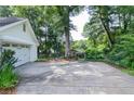 Spacious driveway leading to a detached garage, featuring a basketball hoop and ample parking at 4714 Marc Sw Ct, Lilburn, GA 30047