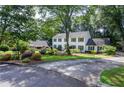 Charming two-story home showcasing a beautifully landscaped front yard with lush greenery and vibrant flowers at 4714 Marc Sw Ct, Lilburn, GA 30047