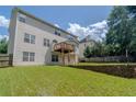 Spacious backyard featuring a tiered deck and lush green grass, perfect for outdoor entertaining at 851 Roget Ct, Lawrenceville, GA 30045
