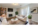 Inviting living room with modern furnishings and a fireplace creates a cozy atmosphere at 2105 Sandtree Sw Ct, Atlanta, GA 30331