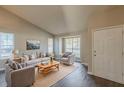 Bright living room with vaulted ceilings, large windows, and hardwood floors at 2105 Sandtree Sw Ct, Atlanta, GA 30331