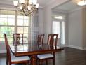 Bright dining room features a chandelier, large windows, and elegant wood furnishings at 4933 Greenard Watson Ln, Buford, GA 30518
