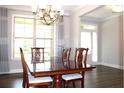 Elegant dining room featuring a wood table, chairs, and decorative chandelier at 4933 Greenard Watson Ln, Buford, GA 30518