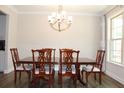 Dining room showcases a classic chandelier, natural light, and a stylish wooden dining set at 4933 Greenard Watson Ln, Buford, GA 30518