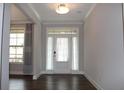 Inviting entryway with transom window and stylish sheer curtains allows natural light into the home at 4933 Greenard Watson Ln, Buford, GA 30518