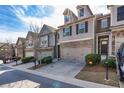 Attractive townhome featuring brick accents, two-car garage, well-maintained landscaping, and modern design at 5008 Whiteoak Pointe Se # 15, Smyrna, GA 30080