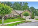Charming brick home featuring a well-manicured lawn and a two-car garage at 1873 Jameson Cir, Lawrenceville, GA 30043