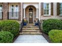 Inviting entryway with stone steps, wrought iron railing, and manicured greenery at 2362 Saint Davids Nw Sq, Kennesaw, GA 30152