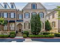 Brick townhome showcasing traditional architecture, well-maintained shrubs, and a welcoming entrance at 2362 Saint Davids Nw Sq, Kennesaw, GA 30152