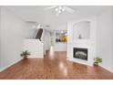Cozy living room with hardwood floors, fireplace, and open layout to kitchen at 2372 Johnson Rd, Atlanta, GA 30345