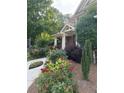Well-maintained front yard featuring lush greenery, colorful flowers, and a walkway to the entrance at 2474 Starfire Ln, Loganville, GA 30052