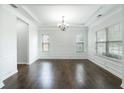 Bright dining room boasts hardwood floors, elegant trim, and a modern chandelier at 60 Copeland Trce, Dallas, GA 30157