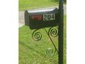 A black mailbox with the house number 204 is displayed on an ornate, wrought iron post at 204 Melanie Ln, Woodstock, GA 30188