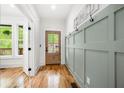 Bright foyer featuring stylish coat hooks, hardwood floors, and natural light at 224 Cambridge Ave, Decatur, GA 30030