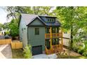 Modern two-story home with a stylish green facade, a private garage, and dual front porches at 224 Cambridge Ave, Decatur, GA 30030