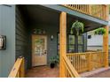 Charming front porch with wooden railing, hanging plants, and decorative door mat at 224 Cambridge Ave, Decatur, GA 30030