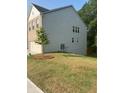 This home has siding and a brick front with a well manicured lawn at 7695 Baron Rd, Fairburn, GA 30213