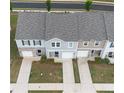 Birds-eye view of townhomes with private driveways and well-maintained landscaping in a neighborhood setting at 124 Saginaw Ct, Locust Grove, GA 30248
