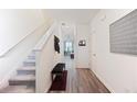 Bright entryway featuring hardwood floors, staircase, and neutral color scheme at 124 Saginaw Ct, Locust Grove, GA 30248