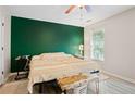 Inviting bedroom featuring a queen bed and a view of the backyard through a window at 561 Holland Rd, Dallas, GA 30157