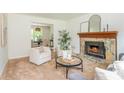 Cozy living room features a stone fireplace, neutral color palette, and comfortable seating arrangement at 350 Birch Rill Dr, Alpharetta, GA 30022