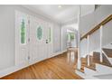 Welcoming foyer featuring hardwood floors, a leaded glass front door, and staircase at 4197 Chadds Xing, Marietta, GA 30062