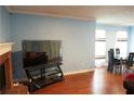 Bright living room with fireplace, hardwood floors, and view into the dining area at 852 Glynn Oaks Dr, Clarkston, GA 30021