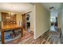 Dining room with rustic wood floors, wooden table, and a stylish sliding barn door to the kitchen at 110 Baltusrol Way, Covington, GA 30014