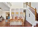 Inviting foyer with hardwood floors, a staircase, and decoratively furnished console table at 475 Cascade Rise, South Fulton, GA 30331