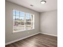 This room features a large window letting in plenty of natural light and hardwood floors at 325 Nutwood Trce, Locust Grove, GA 30248