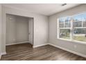 This living room boasts lots of natural light and hardwood floors, creating an inviting space at 325 Nutwood Trce, Locust Grove, GA 30248