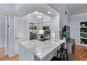 Well-lit kitchen with stainless appliances, marble countertops, and a breakfast bar with seating at 3777 Peachtree Ne Rd # 1313, Brookhaven, GA 30319