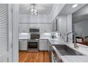 Bright kitchen with stainless steel appliances, white cabinets, and marble countertops at 3777 Peachtree Ne Rd # 1313, Brookhaven, GA 30319